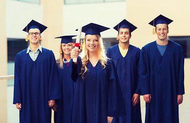 Image showing group of smiling students in mortarboards