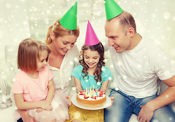 Image showing happy family with two kids in party hats at home