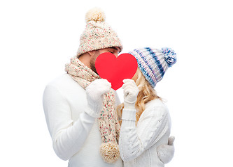 Image showing smiling couple in winter clothes with red heart