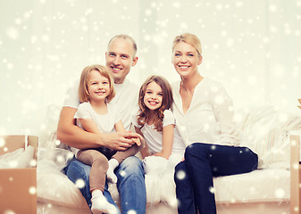 Image showing smiling parents and two little girls at new home