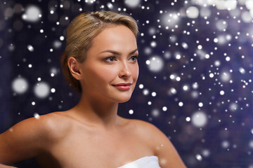 Image showing beautiful woman sitting in bath towel at sauna