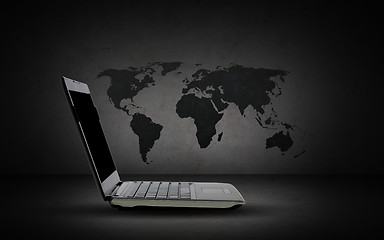 Image showing open laptop computer with world map