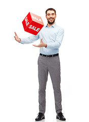 Image showing smiling man with red shopping bag