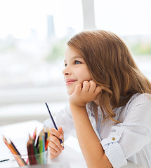 Image showing little student girl drawing and dreaming at school