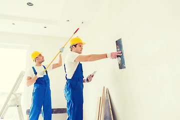 Image showing group of builders with tools indoors