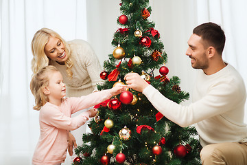 Image showing happy family decorating christmas tree at home