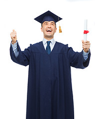 Image showing smiling adult student in mortarboard with diploma