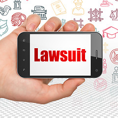 Image showing Law concept: Hand Holding Smartphone with Lawsuit on display