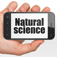 Image showing Science concept: Hand Holding Smartphone with Natural Science on display
