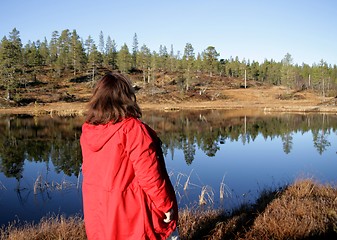 Image showing Woman by a reflective tarn