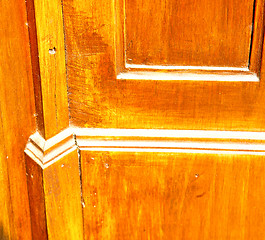 Image showing grain texture of a brown antique wooden old door in italy   euro