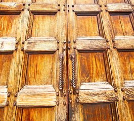 Image showing abstract texture of a brown antique wooden old door in italy   e