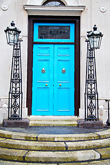 Image showing  blue handle in  door  rusty  brass nail and light