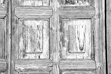 Image showing grain texture of a brown antique wooden old door in italy   euro