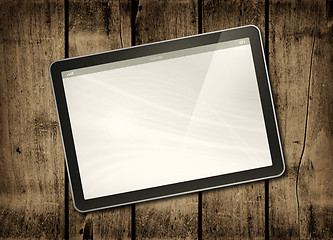 Image showing Digital tablet PC on a dark wood table