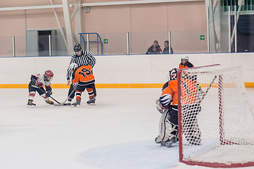 Image showing Puck playing between players of ice-hockey teams