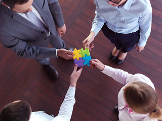 Image showing business people group assembling jigsaw puzzle