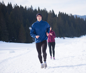 Image showing couple jogging outside on snow