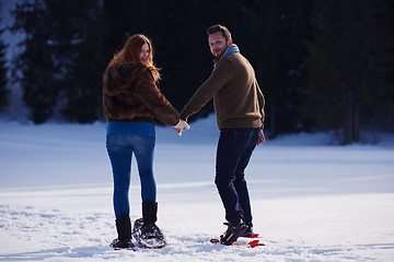 Image showing couple having fun and walking in snow shoes