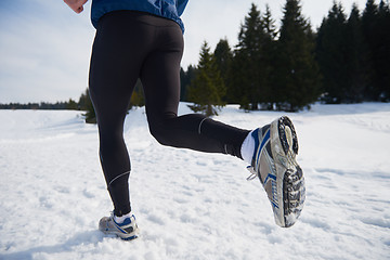 Image showing jogging on snow in forest