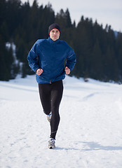 Image showing jogging on snow in forest