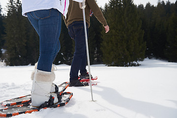 Image showing couple having fun and walking in snow shoes