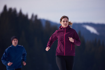 Image showing couple jogging outside on snow