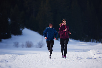 Image showing couple jogging outside on snow