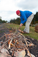 Image showing hiking man try to light fire