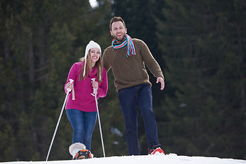 Image showing couple having fun and walking in snow shoes