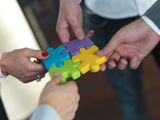 Image showing business people group assembling jigsaw puzzle