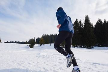 Image showing jogging on snow in forest