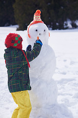 Image showing boy making snowman