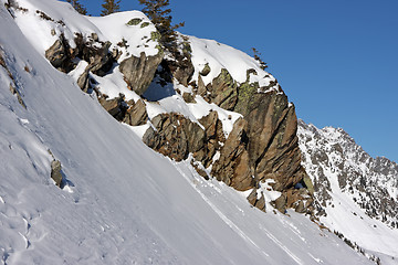 Image showing Boulders on snowy mountain