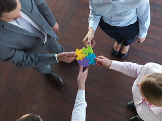 Image showing business people group assembling jigsaw puzzle