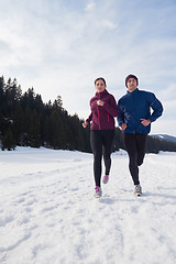 Image showing couple jogging outside on snow