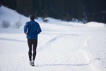 Image showing jogging on snow in forest