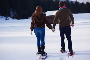 Image showing couple having fun and walking in snow shoes