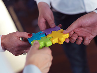 Image showing business people group assembling jigsaw puzzle
