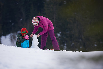 Image showing happy family building snowman