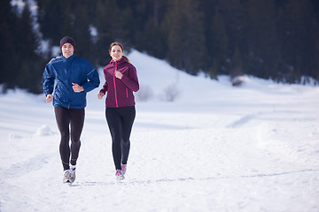 Image showing couple jogging outside on snow