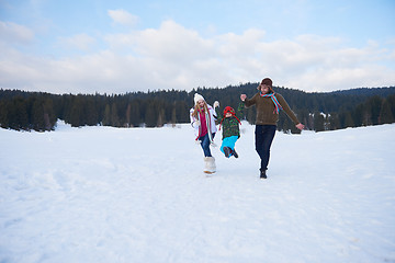 Image showing happy family playing together in snow at winter