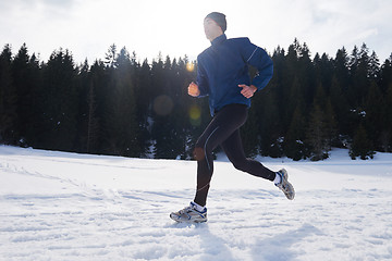 Image showing jogging on snow in forest