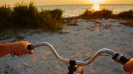 Image showing Hands holding handlebar of bicycle