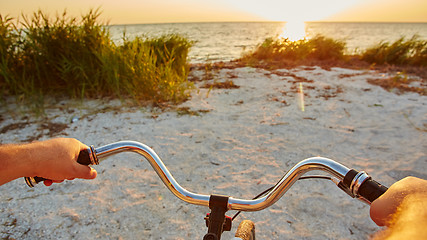 Image showing Hands holding handlebar of bicycle