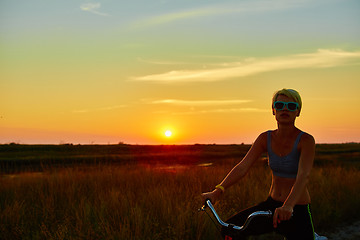 Image showing Biker-girl at the sunset