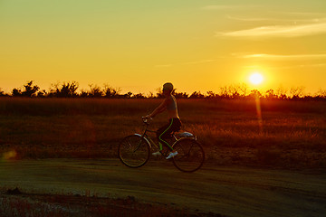 Image showing Biker-girl at the sunset