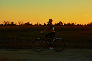 Image showing Biker-girl at the sunset