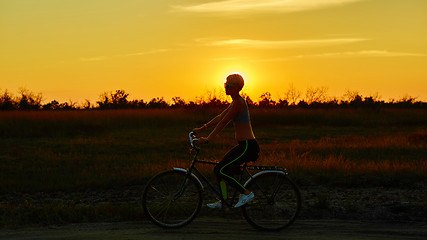 Image showing Biker-girl at the sunset