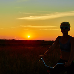 Image showing Biker-girl at the sunset